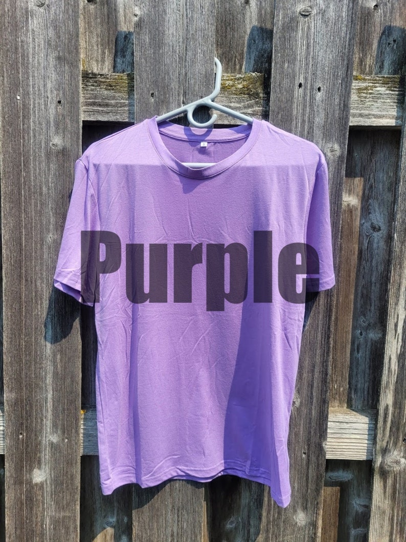 May include: A purple t-shirt with the word "Purple" printed on the front.