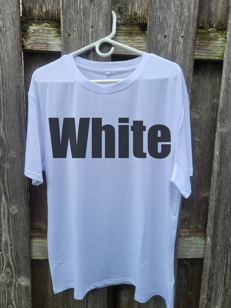 May include: White t-shirt with the word "White" printed in black on the front.
