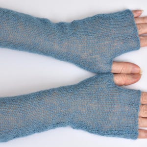 May include: A pair of blue fingerless gloves crafted from a fine, semi-sheer knit material. These arm warmers extend from the knuckles to the mid-forearm, featuring a simple thumb opening and a lightweight, airy texture with a subtle heathered appearance.