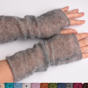 May include: A pair of fingerless gloves made from a sheer, fuzzy gray knit material. The gloves feature a loose, open-weave texture that extends from the knuckles to the mid-forearm, with a simple opening for the thumb and fingers.