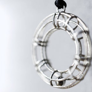 3d printed silver geometrical pendant, circular donut shaped. Graduation gift for architect engineer, designer math teacher, science student