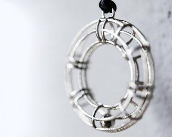 3d printed silver geometrical pendant, circular donut shaped. Graduation gift for architect engineer, designer math teacher, science student