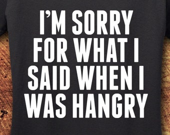 May include: A dark gray t-shirt with white text that reads "I'm sorry for what I said when I was hangry".