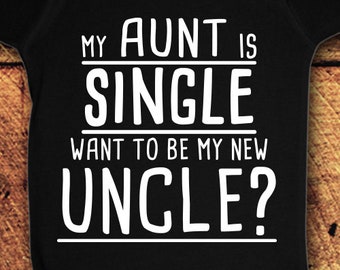 May include: Black baby onesie with white text that reads "My aunt is single want to be my new uncle?"
