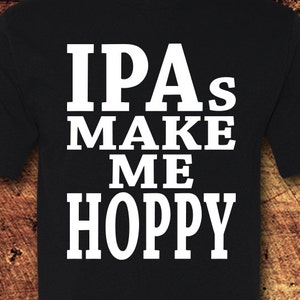 May include: Black t-shirt with white text that reads "IPAs Make Me Hoppy".
