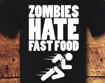 Puede incluir: Camiseta negra con texto blanco que dice "Zombies Hate Fast Food" y una silueta blanca de una persona corriendo.