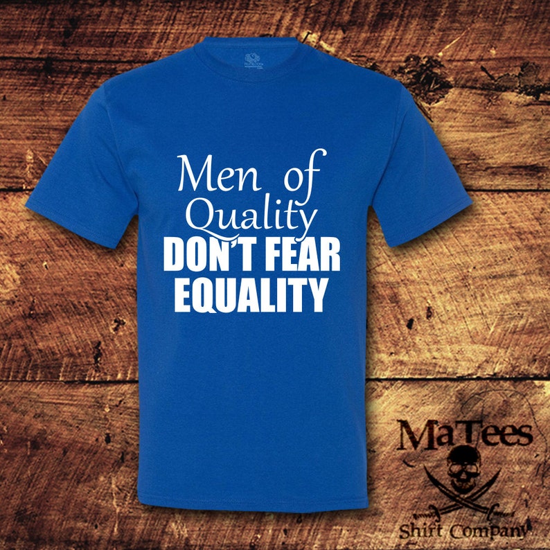 May include: A royal blue t-shirt with white text that reads "Men of Quality Don't Fear Equality".