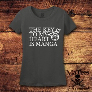 May include: A dark gray t-shirt with a white graphic that says "The key to my heart is manga" with a key and a heart lock design.