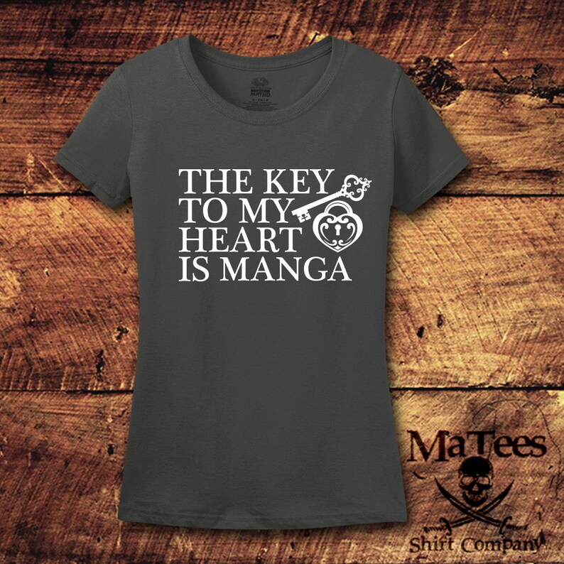 May include: A dark gray t-shirt with a white graphic that says "The key to my heart is manga" with a key and a heart lock design.