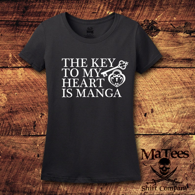 May include: A dark gray t-shirt with a white graphic of a key and a heart lock with the text "The key to my heart is manga".