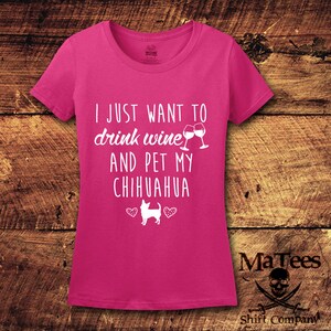 May include: Pink women's t-shirt with white text that reads "I just want to drink wine and pet my chihuahua" with a graphic of two wine glasses clinking and a chihuahua with hearts.
