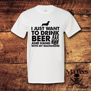May include: White t-shirt with a black dachshund silhouette and the text "I just want to drink beer and hang with my dachshund".