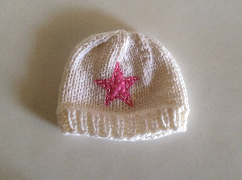Hand Knit child\u2019s pink and white star hat