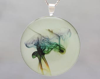 Glow in the dark pendant featuring rainbow coloured smoke -  Beautiful abstract image showing science  of air patterns