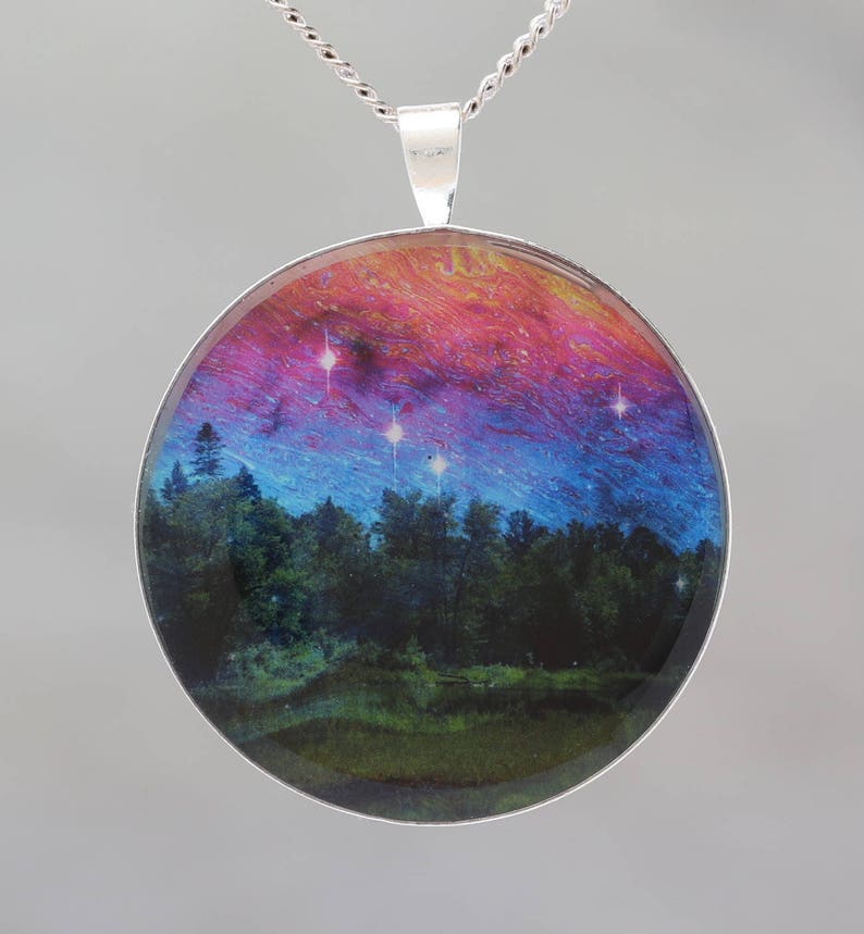 Dancing Sky Glow-in-the-dark pendant with a surreal image of trees image 1