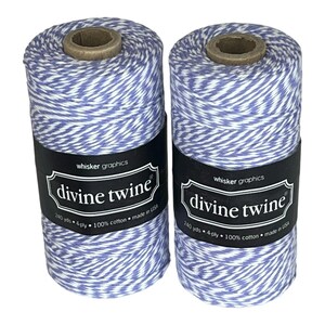 May include: Two spools of Divine Twine, each with a blue and white striped pattern. The black label reads "whisker graphics" and "divine twine". Each spool contains 240 yards of 4-ply, 100% cotton twine, made in the USA.