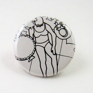 May include: A white button with a black and white line drawing of a person in a swimsuit holding a ring.