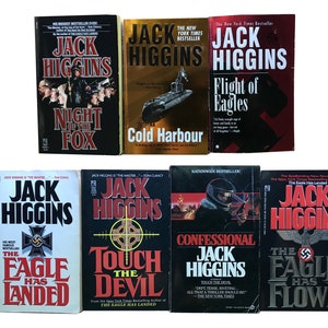 May include: A collection of ten paperback books by Jack Higgins. The books are all in the same style, with a black background and white text. The titles of the books are "Night of the Fox", "Cold Harbour", "Flight of Eagles", "The Eagle Has Landed", "Touch the Devil", "Confessional", "The Eagle Has Flown".