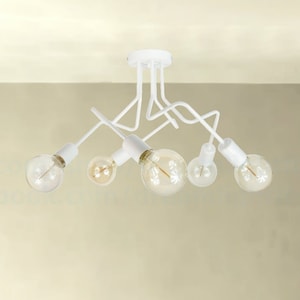 May include: White ceiling light fixture with six white bulbs. The fixture has a modern design with curved arms.