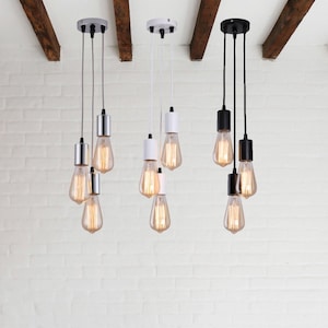 May include: Three sets of pendant lights with exposed bulbs hanging from the ceiling. The lights are in three different finishes: chrome, white, and black.