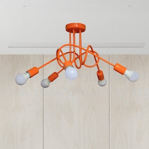 May include: Orange ceiling light fixture with five bulbs. The light fixture has a modern, abstract design with a twisted metal frame.