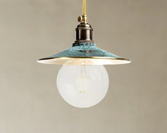 May include: A teal green pendant light with a brass trim and a clear glass globe light bulb.