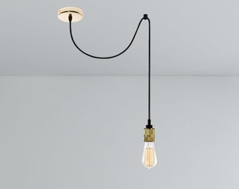 May include: A black electrical cord hangs from the ceiling with a gold ceiling plate. The cord is looped and ends with a gold light socket and a clear light bulb.