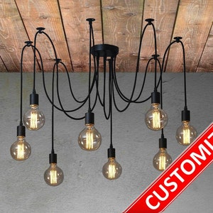 May include: A multi-arm spider chandelier featuring seven black pendant light fixtures with exposed filament bulbs suspended by black fabric cords. The fixture includes a colour palette sidebar showing various cord options and the text CUSTOMIZED.