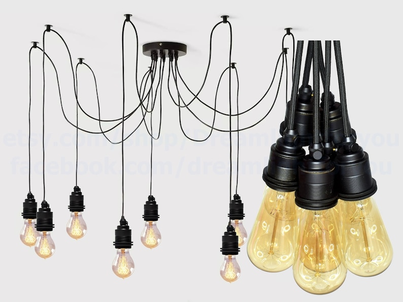 May include: Black pendant light fixture with eight black cords and eight clear glass bulbs. The cords are suspended from a black ceiling plate.