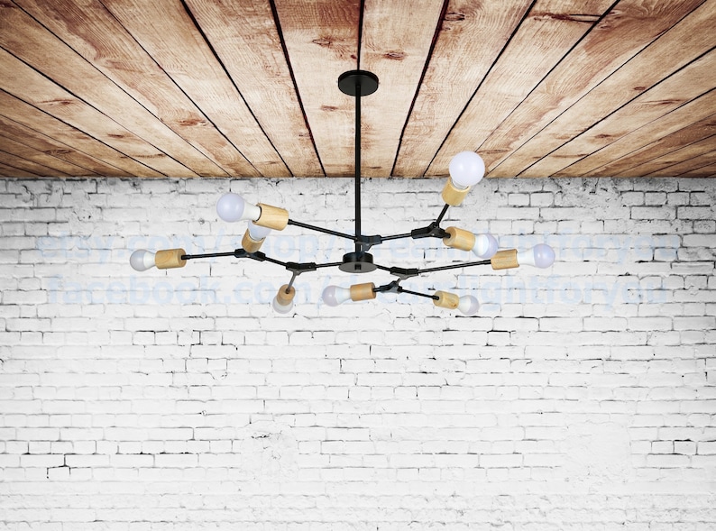 May include: A black metal chandelier with wooden accents and multiple light bulbs. The chandelier is hanging from a wooden ceiling.