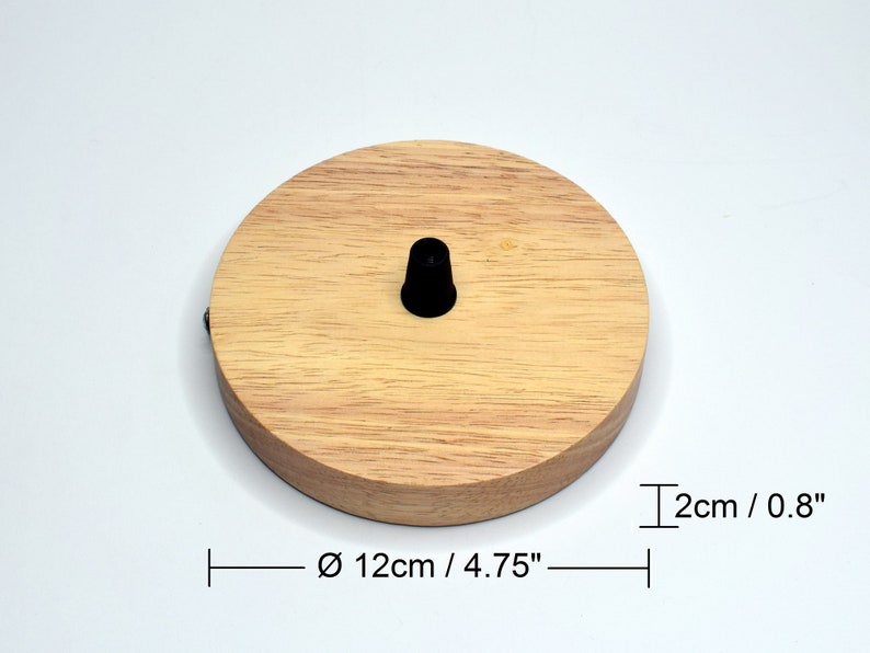 May include: A round wooden ceiling rose with a black cord grip. The ceiling rose measures 4.75 inches in diameter and 0.8 inches in height.