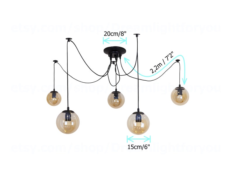 May include: Black pendant light fixture with five amber glass globe shades. The fixture has adjustable cords, with a maximum length of 72 inches and a width of 20 inches. The globes are 6 inches in diameter.