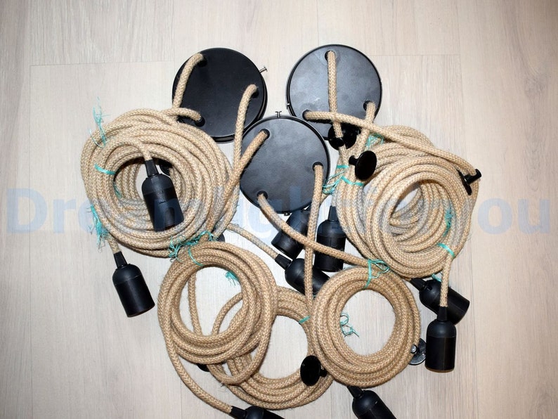 May include: A set of six black electrical cord ends with natural jute rope covered cords. The cords are bundled together and ready to be installed.