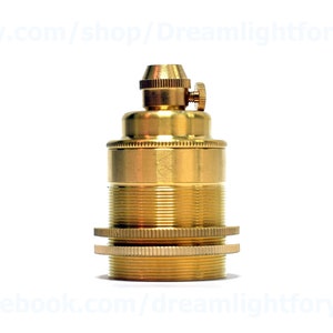 May include: A brass light bulb socket with a threaded top and a screw-on cap. The socket is designed for use with vintage-style light bulbs.