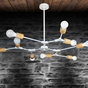 May include: White modern chandelier with wooden accents and eight light bulbs. The chandelier has a simple design with straight lines and a central hub.