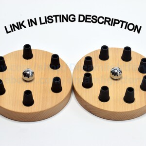 May include: Two wooden bases with black rubber grommets and a silver ball in the center of each. The bases are labeled "LINK IN LISTING DESCRIPTION".