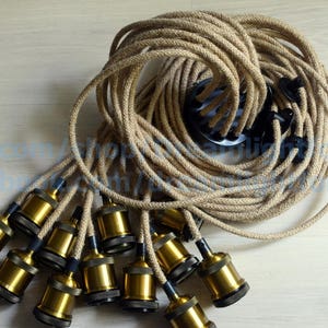 May include: A set of 10 gold-colored light bulb sockets with a natural jute cord. The cord is coiled and ready to be used for a DIY lighting project.