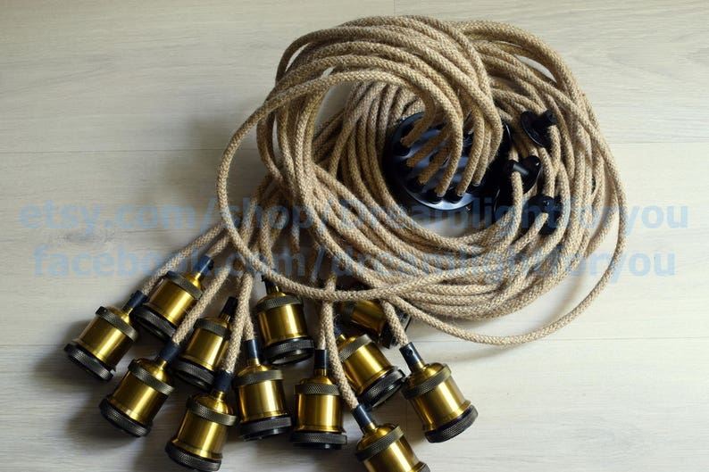 May include: A set of 10 gold-colored light bulb sockets with a natural jute cord. The cord is coiled and ready to be used for a DIY lighting project.