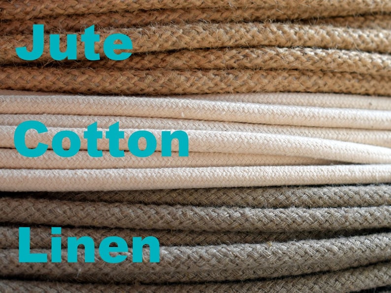 May include: Close-up of three different types of rope: jute, cotton, and linen. The jute rope is brown, the cotton rope is white, and the linen rope is a light brown.