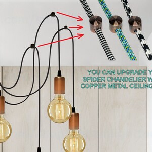 May include: A black spider chandelier with copper metal ceiling clips. The chandelier has six light bulbs and black cords. The text "YOU CAN UPGRADE YOUR SPIDER CHANDELIER WITH A COPPER METAL CEILING CLIPS" is visible in the image.