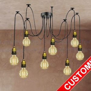 May include: A black metal chandelier with eight light bulbs. The bulbs are round and have a warm white glow. The chandelier has a spider-like design with multiple arms that extend out from the center. The chandelier is hanging from the ceiling. The word "CUSTOMIZED" is written in red on a white background in the lower right corner of the image.