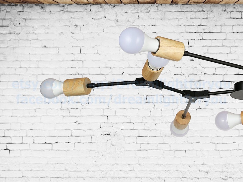 May include: A modern black and wood ceiling light fixture with five light bulbs. The fixture has a geometric design with multiple arms extending from a central point.