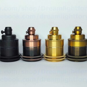 May include: Four different colored electrical lamp sockets. The sockets are made of metal and have a threaded design. The colors are black, copper, brass, and antique brass.