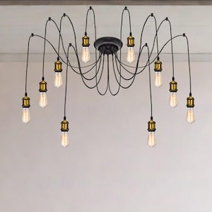 Könnte beinhalten: Schwarzer Spinnen-Kronleuchter mit zehn Edison-Glühbirnen. Die Leuchte hat ein schwarzes Baldachin und Arme mit goldfarbenen Fassungen. Die Glühbirnen sind klar und haben eine Vintage-Ästhetik, ideal für einen modernen oder industriellen Raum.