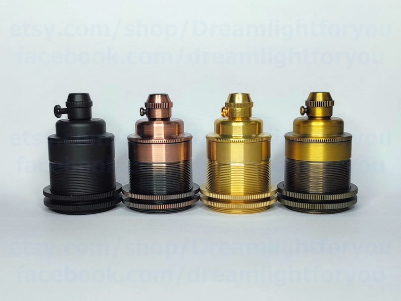 May include: Four different colored electrical lamp sockets. The sockets are made of metal and have a threaded design. The colors are black, copper, brass, and antique brass.