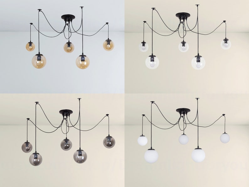 May include: Four different styles of a six-light pendant chandelier with black cords and round glass globes. The globes are clear, amber, smoked glass, and white.