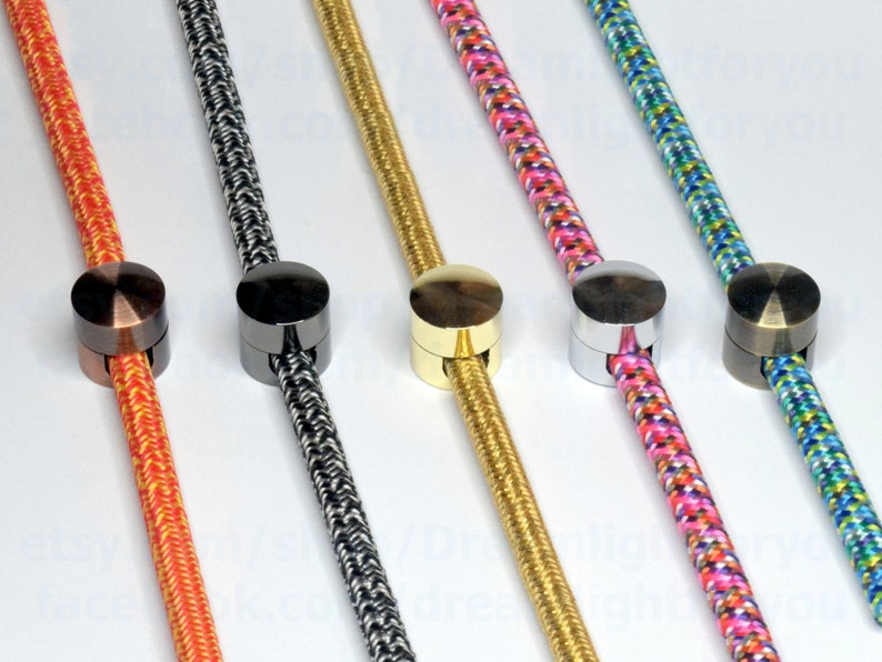 May include: Five different colored cords with metal cord end caps. The cords are orange, black and white, gold, pink and white, and blue, white, and green. The end caps are copper, black, gold, silver, and bronze.