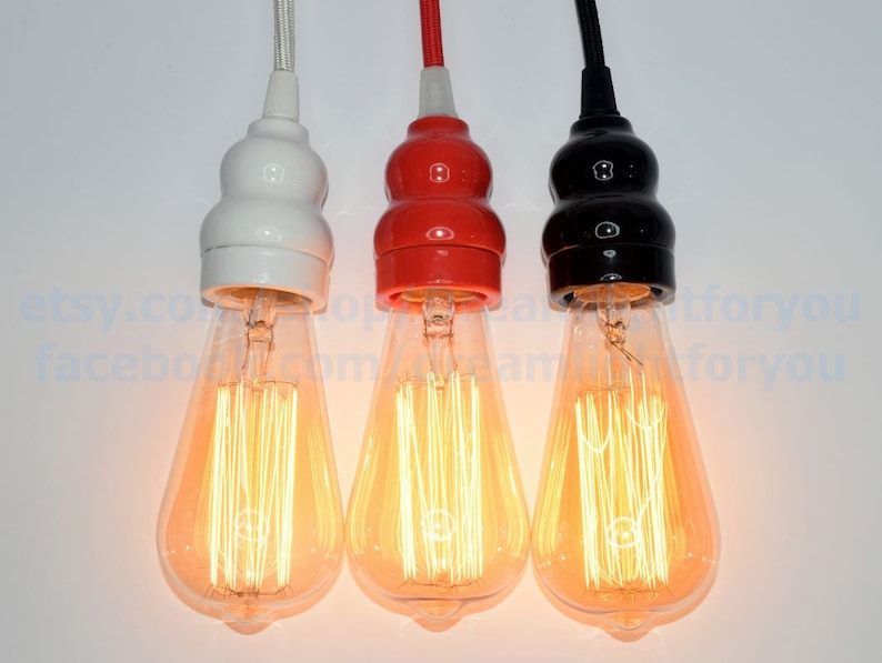 May include: Three pendant light fixtures with clear glass bulbs and ceramic lamp holders in white, red, and black.
