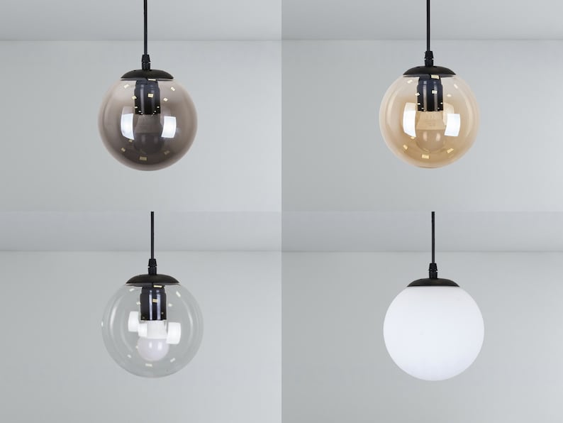 May include: Four pendant lights with different glass shades. The shades are clear, frosted, amber, and brown.