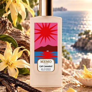 May include: A rectangular white perfume bottle with a metallic cap, featuring a label with a pink sun, brown hills, and blue water. The text on the label reads MEMO PARIS CAP CAMARAT EAU DE PARFUM fleurs bohèmes in black and gold lettering.